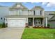 Charming two-story home featuring stone accents, a well-manicured lawn, and a two-car garage at 5115 Heathland Dr # 47, Charlotte, NC 28215