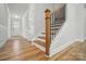 The house foyer features hardwood floors, wood stairs, and white wainscoting at 5115 Heathland Dr # 47, Charlotte, NC 28215