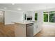Open concept kitchen with a center island seamlessly connects to the cozy living room at 5115 Heathland Dr # 47, Charlotte, NC 28215
