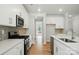 Well-lit kitchen showcases white cabinets, stainless steel appliances, and sleek countertops at 5115 Heathland Dr # 47, Charlotte, NC 28215