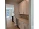 Modern kitchen with white cabinets, stainless steel appliances, and a built-in wine fridge at 5115 Heathland Dr # 47, Charlotte, NC 28215