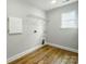 Laundry room featuring wood-look flooring, a utility sink, and a storage cabinet at 5115 Heathland Dr # 47, Charlotte, NC 28215