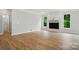 Spacious living room featuring hardwood floors, a modern fireplace, and lots of natural light at 5115 Heathland Dr # 47, Charlotte, NC 28215