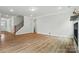 Spacious living room featuring hardwood floors, a modern fireplace, and a staircase nearby at 5115 Heathland Dr # 47, Charlotte, NC 28215