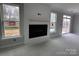 Bright living room with fireplace, shiplap accent, and large windows at 5115 Heathland Dr # 47, Charlotte, NC 28215