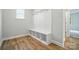Mud room features built-in bench and cubbies and hardwood style floor at 5115 Heathland Dr # 47, Charlotte, NC 28215