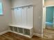 Functional mudroom with built-in storage, coat hooks, and hardwood flooring, perfect for organization at 5115 Heathland Dr # 47, Charlotte, NC 28215