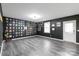 Large entertainment room with luxury vinyl plank flooring and dark gray walls at 8905 Valleymoon Ln, Charlotte, NC 28214