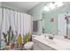 Bathroom featuring white vanity, neutral walls, and a cactus shower curtain at 8905 Valleymoon Ln, Charlotte, NC 28214