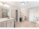 Bright bathroom with double vanity sinks, a walk-in shower, and tiled floors for a clean and modern look at 8905 Valleymoon Ln, Charlotte, NC 28214
