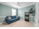 Comfortable bedroom with blue walls, carpeted floors, and natural light at 8905 Valleymoon Ln, Charlotte, NC 28214