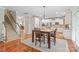 Dining area with hardwood floors, a table and chairs, and a view of the kitchen at 8905 Valleymoon Ln, Charlotte, NC 28214