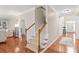 Welcoming foyer with hardwood floors and a carpeted staircase leads to the upper level of the home at 8905 Valleymoon Ln, Charlotte, NC 28214