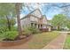 Beautiful two-story home featuring professional landscaping, a brick retaining wall and multi-car garage at 8905 Valleymoon Ln, Charlotte, NC 28214