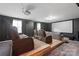 Home theater with tiered seating, including leather recliners and a large screen at 8905 Valleymoon Ln, Charlotte, NC 28214