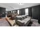 Home theater with tiered seating, including leather recliners and a gray couch at 8905 Valleymoon Ln, Charlotte, NC 28214