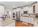 Gourmet kitchen featuring stainless appliances, granite countertops, and custom cabinetry at 8905 Valleymoon Ln, Charlotte, NC 28214