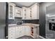 Features a stylish kitchenette with white cabinets, granite countertop, and modern stainless steel refrigerator at 8905 Valleymoon Ln, Charlotte, NC 28214