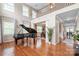 Spacious living area with hardwood floors, staircase, and an open view to the dining room at 8905 Valleymoon Ln, Charlotte, NC 28214