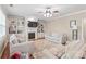 Spacious living room with a fireplace, built-in bookshelves, and a ceiling fan at 8905 Valleymoon Ln, Charlotte, NC 28214
