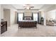 Serene main bedroom with tray ceilings, a dark wood bed frame, and a cozy seating area with soft carpeting at 8905 Valleymoon Ln, Charlotte, NC 28214