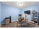 A blue-walled office space featuring a desk, computer setup, shelving, and natural light from the window at 8905 Valleymoon Ln, Charlotte, NC 28214