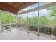 Relaxing screened porch with vaulted ceiling and views of lush greenery at 8905 Valleymoon Ln, Charlotte, NC 28214