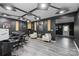 View of a well-lit music recording studio with sound-proofing, instruments, and modern gray flooring at 8905 Valleymoon Ln, Charlotte, NC 28214