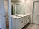 Modern bathroom with double vanity, large mirror, and tile flooring at 102 Obadiah Ct, Troutman, NC 28115
