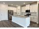 Spacious kitchen with island, stainless steel appliances, and granite countertops at 102 Obadiah Ct, Mooresville, NC 28115