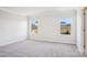 Bedroom featuring neutral carpet and two windows that provide natural lighting at 102 Obadiah Ct, Troutman, NC 28115