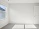 A bright bedroom with a window and neutral carpet creating a cozy space at 102 Obadiah Ct, Troutman, NC 28115