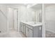 Stylish bathroom showcasing double vanities with a large mirror at 103 Obadiah Ct, Mooresville, NC 28115