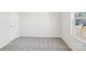 Bright bedroom with neutral carpet and a window overlooking the neighborhood at 103 Obadiah Ct, Mooresville, NC 28115