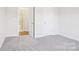 Bright bedroom featuring neutral carpet with closet and open entry to a bathroom at 103 Obadiah Ct, Mooresville, NC 28115
