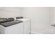 Modern laundry room with white washer, dryer, and wire shelf at 103 Obadiah Ct, Mooresville, NC 28115
