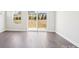 Bright living room with hardwood floors and sliding glass doors leading to the backyard at 103 Obadiah Ct, Mooresville, NC 28115