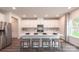 Modern kitchen with white cabinets, center island, and stainless steel appliances at 107 Obadiah Ct, Troutman, NC 28115