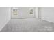 Bright, carpeted bedroom with two windows and a door leading to the hallway at 107 Obadiah Ct, Troutman, NC 28115