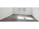 Bright bedroom with luxury vinyl plank flooring, white walls, and two windows at 107 Obadiah Ct, Troutman, NC 28115