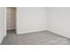 Cozy bedroom features a carpeted floor and a door leading to a walk-in closet at 107 Obadiah Ct, Troutman, NC 28115