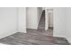 Open living room space with luxury vinyl plank flooring, neutral paint, and staircase access at 107 Obadiah Ct, Troutman, NC 28115