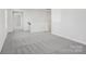 Open loft area with neutral carpet and a view of the lower level at 107 Obadiah Ct, Troutman, NC 28115