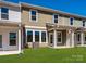Backyard with green grass and the exterior of the home at 149 Halite Ln, Waxhaw, NC 28173