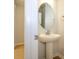 Elegant half bath with pedestal sink, oval mirror and modern fixtures at 149 Halite Ln, Waxhaw, NC 28173