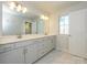 Bright bathroom with a double sink vanity, large mirror, and marble floors at 149 Halite Ln, Waxhaw, NC 28173