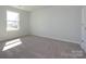 Bedroom with neutral carpet, a window and a white door at 149 Halite Ln, Waxhaw, NC 28173