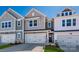 New two-story townhome featuring attached garage and neutral-tone siding with stone accents at 149 Halite Ln, Waxhaw, NC 28173