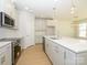 Well lit kitchen featuring an island, stainless appliances, and hardwood floors at 149 Halite Ln, Waxhaw, NC 28173