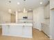 Kitchen with a central island, stainless appliances, and hardwood flooring at 149 Halite Ln, Waxhaw, NC 28173